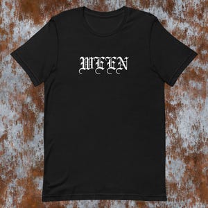 May include: Black t-shirt with the word "WEEN" printed in white in a gothic font.