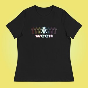 May include: Black t-shirt with a graphic of stick figures in various colors holding hands above the word "ween" in a gradient font. The shirt is a relaxed fit.