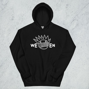 May include: Black hooded sweatshirt with a white graphic design. The design features a stylized face with the word "WEEN" in white block letters. The sweatshirt has a front pocket and a drawstring hood.