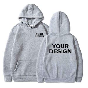 May include: A light grey hooded sweatshirt featuring a front kangaroo pocket and long sleeves. The text "YOUR DESIGN" is printed in black on the upper left chest and in a larger size across the centre of the back of the garment.