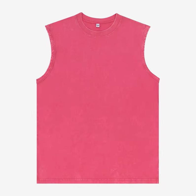 Puede incluir: Una camiseta sin mangas, con cuello redondo, de color fucsia vibrante. La prenda tiene un aspecto ligeramente descolorido, lo que le da un aspecto vintage o desgastado. La tela parece ser un material suave y transpirable, adecuado para climas c&aacute;lidos.