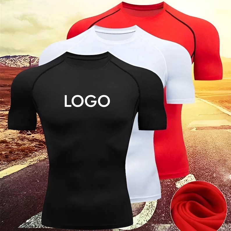 men’s half sleeve compression shirts displayed in black, red, and gray, featuring custom logo placement on the chest. The athletic shirts have a tight-fitting design with contrast panel stitching, ideal for gym workouts, running, training, and sports activities. Made from quick-dry polyester elastane fabric, these performance tops offer flexibility, breathability, and muscle support. Suitable for custom branding, team uniforms, and personalized activewear, available in multiple sizes and colors.