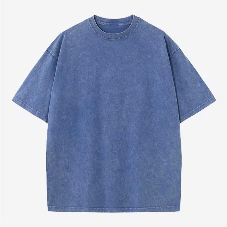 Może przedstawiać: Niebieski t-shirt z kr&oacute;tkim rękawem o wyblakłym, teksturowanym wyglądzie. Koszulka ma okrągły dekolt i luźny kr&oacute;j. Tkanina wydaje się być miękką mieszanką bawełny, odpowiednią do noszenia na co dzień. T-shirt jest w jednolitym kolorze bez widocznych grafik ani wzor&oacute;w.