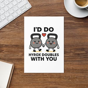 May include: A white card featuring the text "I'D DO HYROX DOUBLES WITH YOU" and two cartoon kettlebells holding hands. The kettlebells are grey with smiling faces and small black feet. A red heart is between the words "DO" and the kettlebells.