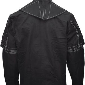 May include: Black long-sleeved jacket with white stitching detail. The jacket has a high collar and a unique design with a pointed collar.
