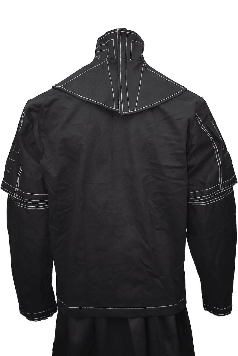 May include: Black long-sleeved jacket with white stitching detail. The jacket has a high collar and a unique design with a pointed collar.