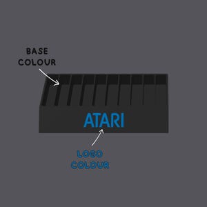 May include: A black rectangular storage rack with ten vertical slots and the blue text ATARI printed on the front. White arrows and text labels point to the base and the logo, reading BASE COLOUR and LOGO COLOUR respectively.