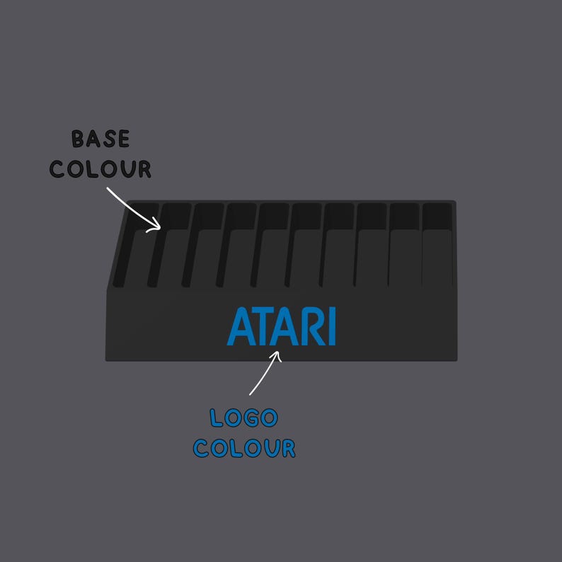 May include: A black rectangular storage rack with ten vertical slots and the blue text ATARI printed on the front. White arrows and text labels point to the base and the logo, reading BASE COLOUR and LOGO COLOUR respectively.