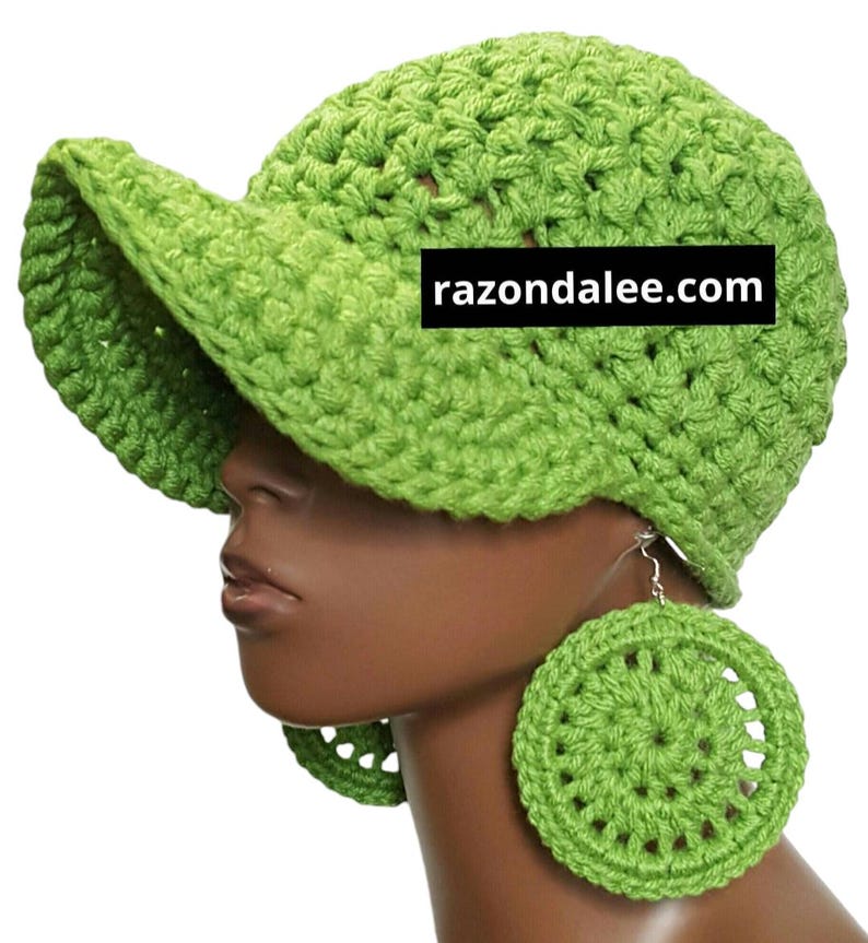 May include: A lime green crocheted hat with a visor and matching circular earrings. The hat and earrings are made of a textured yarn. The website razondalee.com is printed on the hat.