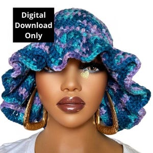 May include: A crocheted bucket hat with a ruffled brim in shades of teal, purple, and blue. The hat is worn by a person with gold hoop earrings.
