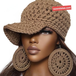 May include: A brown crocheted baseball cap with a textured stitch pattern and a matching pair of large, circular, open-work crocheted earrings. A red rectangular tag with the white text razondalee.com is attached to the cap.