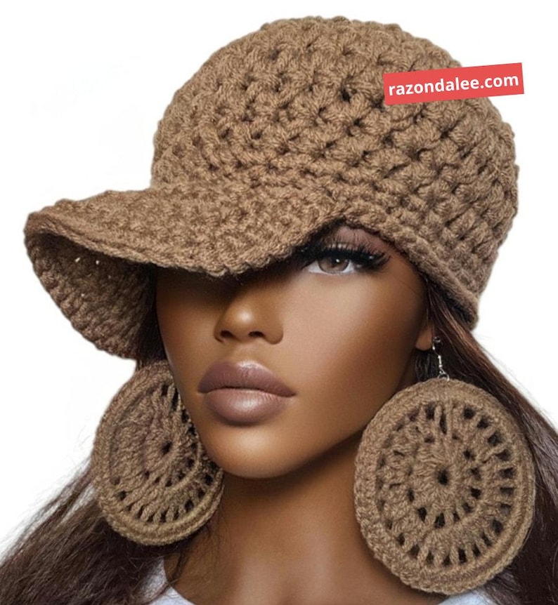May include: A brown crocheted baseball cap with a textured stitch pattern and a matching pair of large, circular, open-work crocheted earrings. A red rectangular tag with the white text razondalee.com is attached to the cap.