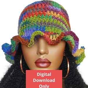 May include: A colourful crochet bucket hat with a ruffled brim. The hat is made with a variety of colours, including red, orange, yellow, green, blue, purple, and brown. The hat is being worn by a mannequin with long, curly black hair. The text "Digital Download Only" is visible in the image.