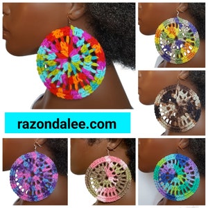 May include: Large circular crochet earrings featuring intricate openwork patterns in various multi-colored yarn combinations, including bright rainbow, earth tones, and pastel palettes. Each earring hangs from a simple metal hook. Text reads razondalee.com.