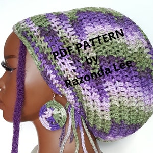 May include: A purple, green, and gray crochet hat with a long, crocheted tassel. The hat is being worn by a person with purple dreadlocks. The text "PDF PATTERN by Razonda Lee" is visible on the hat.