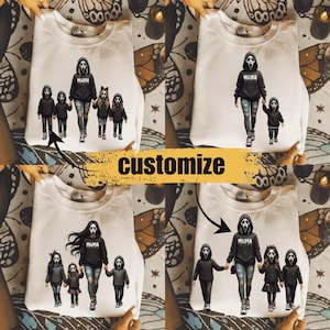 May include: A beige crewneck sweatshirt featuring four variations of a graphic print showing a central figure in a black hoodie with a ghost mask and the word MAMA, accompanied by smaller figures in matching ghost masks and black hoodies.