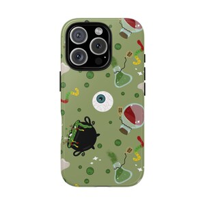 May include: Green phone case featuring a repeating pattern of cartoon witch-themed illustrations. The design includes a cauldron, potion bottles, an eyeball, and a worm. The case has a camera cutout and side buttons.