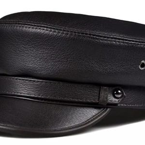 May include: A black leather newsboy cap with a wide brim and a strap with a button closure.