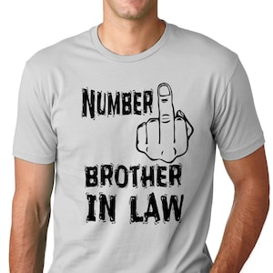 May include: A gray t-shirt with black text that reads "Number 1 Brother in Law" and a black silhouette of a middle finger.