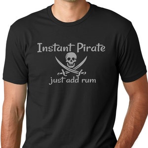 May include: Black t-shirt with a white skull and crossbones graphic and the text "Instant Pirate just add rum".