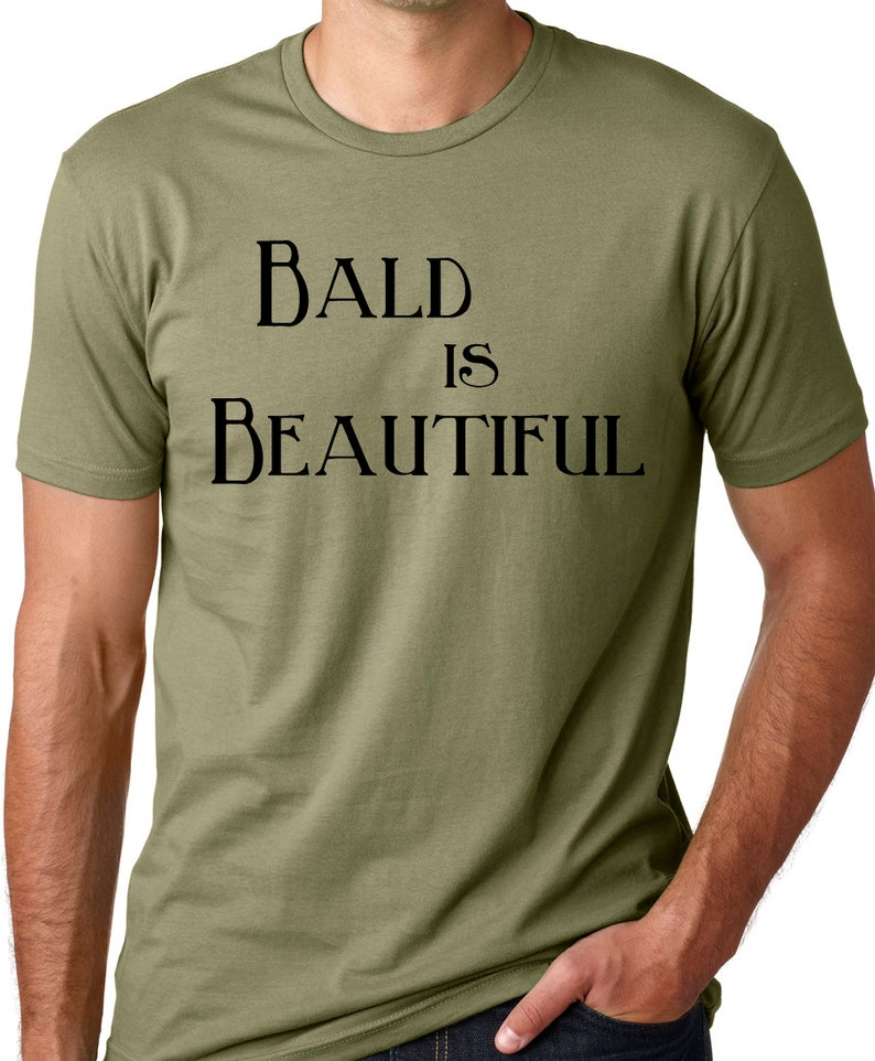 May include: A green t-shirt with the text "BALD IS BEAUTIFUL" printed in black.