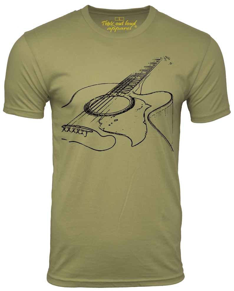 Graphic t-shirt with an acoustic guitar image on chest area short sleeve light olive man shirt with black image of a guitar musician man Tshirt