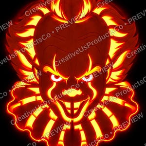 May include: A glowing orange and yellow carved pumpkin design featuring the face of a clown with spiky hair, a ruffled collar, and an intense expression, set against a solid black background with repeating watermark text.