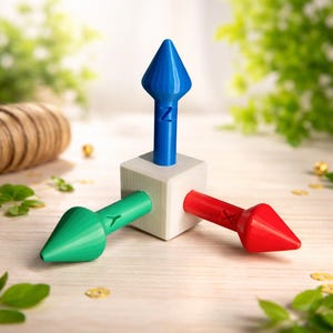 May include: A set of three ceramic mugs with a speckled, cream-colored glaze. Each mug features a different hand-painted floral design in shades of blue, green, and yellow. The mugs have a simple, rounded shape and a comfortable handle.