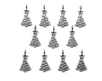 May include: A collection of eleven silver-toned metal charms, each shaped like a Christmas tree with a star at the top. The charms feature a textured, layered design and include a small loop at the apex for attachment to jewelry or crafts.
