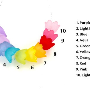 May include: A rainbow-colored necklace with ten flower-shaped beads. The beads are in the following order: purple, light purple, blue, aqua, green, yellow, orange, red, pink, and light pink.