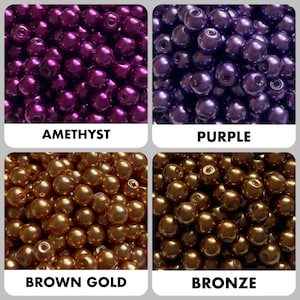 May include: A collection of round beads in four distinct colors: amethyst, purple, brown gold, and bronze. Each section displays a cluster of smooth, spherical beads with a glossy finish, labeled with their respective color names below.