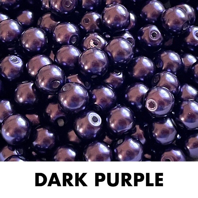 May include: A collection of round, dark purple beads with a smooth, glossy finish. Each bead features a central hole for threading. The text "DARK PURPLE" is printed in bold, black, sans-serif capital letters at the bottom of the image.