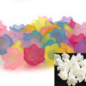 May include: Assortment of colorful plastic flower-shaped beads, with a close-up of white plastic flower-shaped beads.