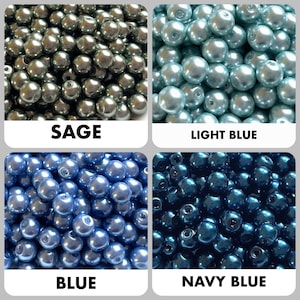 May include: A collection of four groups of round, smooth, lustrous beads in sage, light blue, blue, and navy blue. Each section is labeled with its respective color name: SAGE, LIGHT BLUE, BLUE, and NAVY BLUE, displayed in bold text.