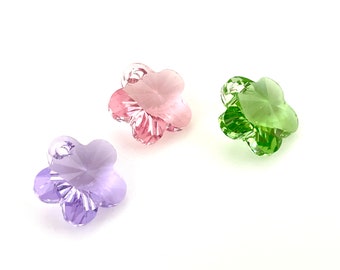 May include: Three crystal flower charms in pink, green, and purple.