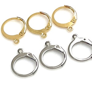 May include: Five earring findings, two gold and three silver, with a clip-on closure.