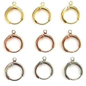 May include: Nine earring findings in three different colors: gold, rose gold, and silver. Each finding is a small, round hoop with a hinged clasp.