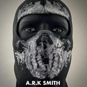 May include: Black balaclava featuring a white graphic design on the front and top. The balaclava covers the head and neck, with only the eyes visible. The text "A.R.K SMITH" is printed at the bottom.