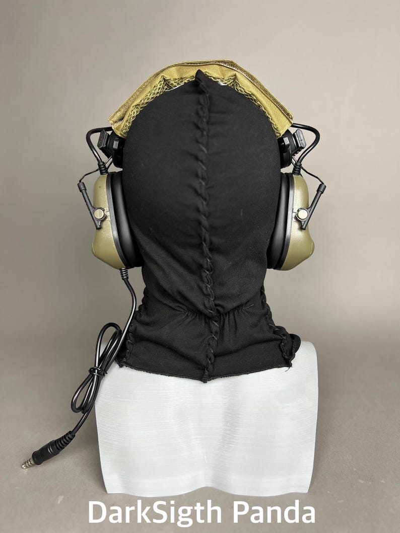 May include: Black balaclava with olive green headphones and a gold-colored mesh top. The headphones have black accents and a connecting wire. The text "DarkSigth Panda" is at the bottom of the image.