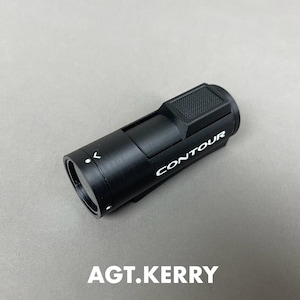 May include: A black Contour camera with the brand name in white lettering. The camera has a textured top and a lens on one end. The text "AGT.KERRY" is at the bottom of the image.