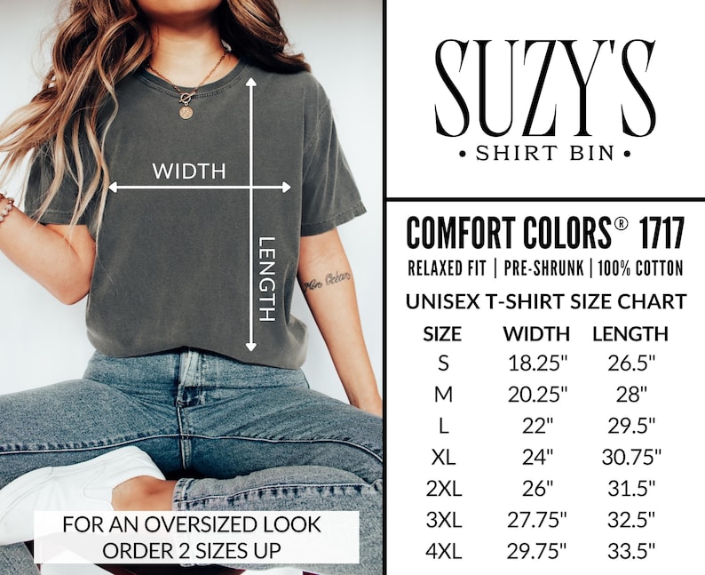 May include: A dark grey unisex t-shirt with a size chart and the text "SUZY'S SHIRT BIN." The shirt is shown on a person wearing blue jeans. The size chart shows measurements in inches for width and length.