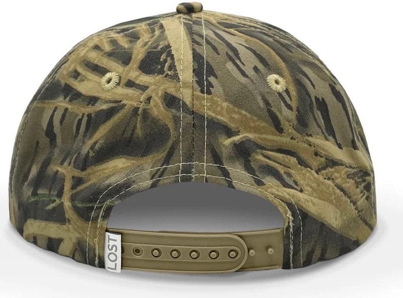 May include: A camouflage baseball cap with a brown adjustable strap and the word "LOST" printed on the side.