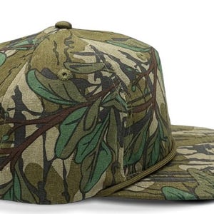 May include: A green and brown camouflage baseball cap with a flat brim.