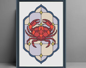 May include: Framed cross-stitch artwork depicting a red crab. The crab is the focal point, set against a backdrop of light purple, yellow, and white squares within a blue-edged frame. The piece is presented in a dark blue frame.