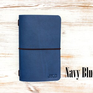 Navy blue leather travelers notebook with personalized initials.