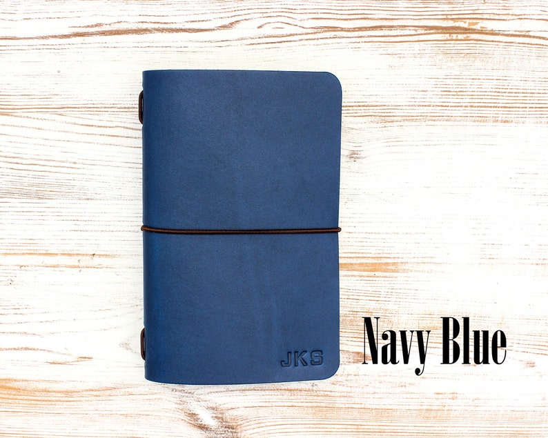 Navy blue leather travelers notebook with personalized initials.
