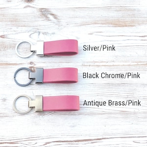 May include: Three pink keychains with metal hardware. The top keychain has silver hardware labelled Silver/Pink. The middle keychain has black chrome hardware labelled Black Chrome/Pink. The bottom keychain has antique brass hardware labelled Antique Brass/Pink.