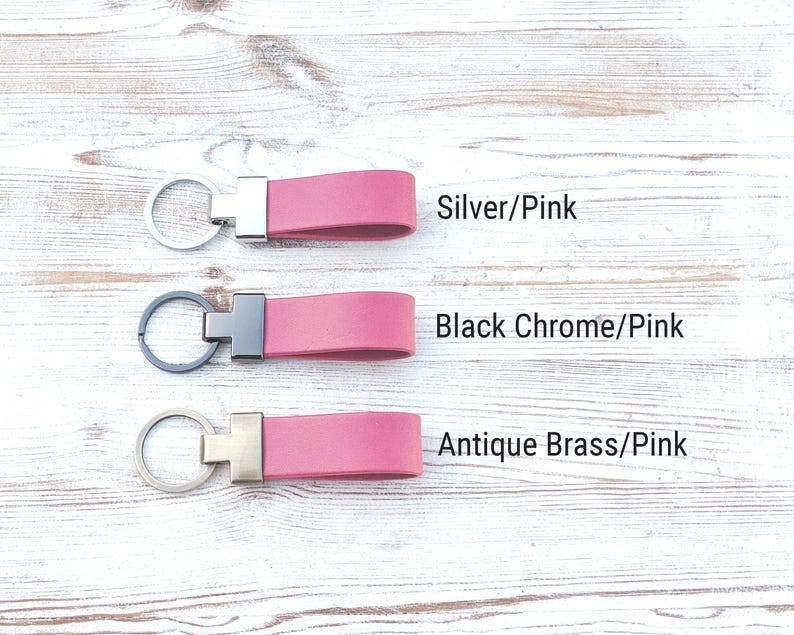 May include: Three pink keychains with metal hardware. The top keychain has silver hardware labelled Silver/Pink. The middle keychain has black chrome hardware labelled Black Chrome/Pink. The bottom keychain has antique brass hardware labelled Antique Brass/Pink.