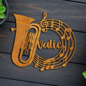 May include: A wooden musical-themed decoration featuring a tuba and musical notes. The word "Valic" is centered within a circle of musical notes. The design is made of light brown wood and is set against a dark wood background.