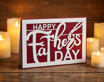 May include: A rectangular greeting card with a deep red background and a white die-cut overlay featuring the text HAPPY FATHER'S DAY. The design incorporates a wrench and pliers integrated into the lettering, creating a layered, dimensional look.